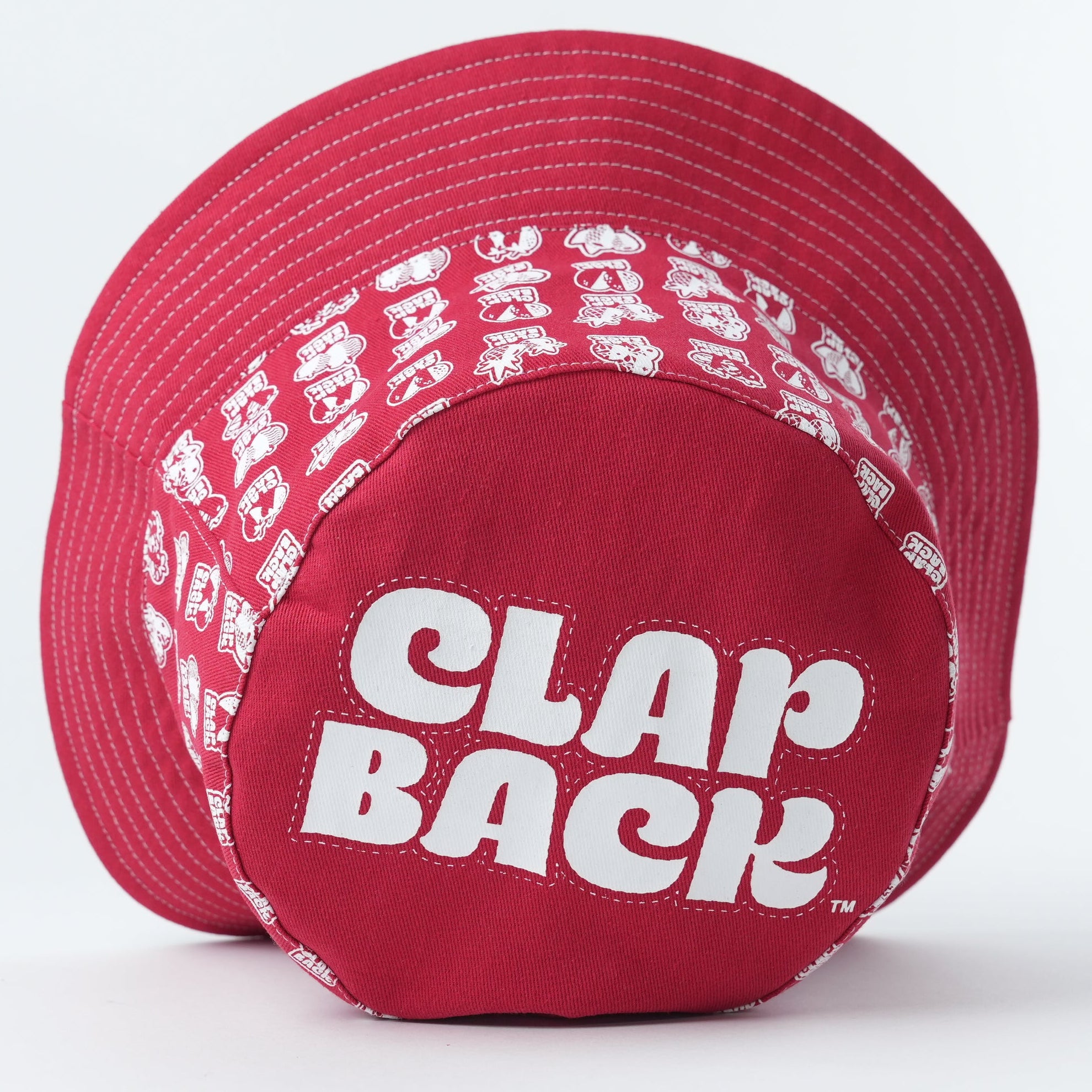 A red structured baseball cap with a white 'CLAP BACK' logo on the front and a white repeating pattern around the side panels, shown on a light gray background.