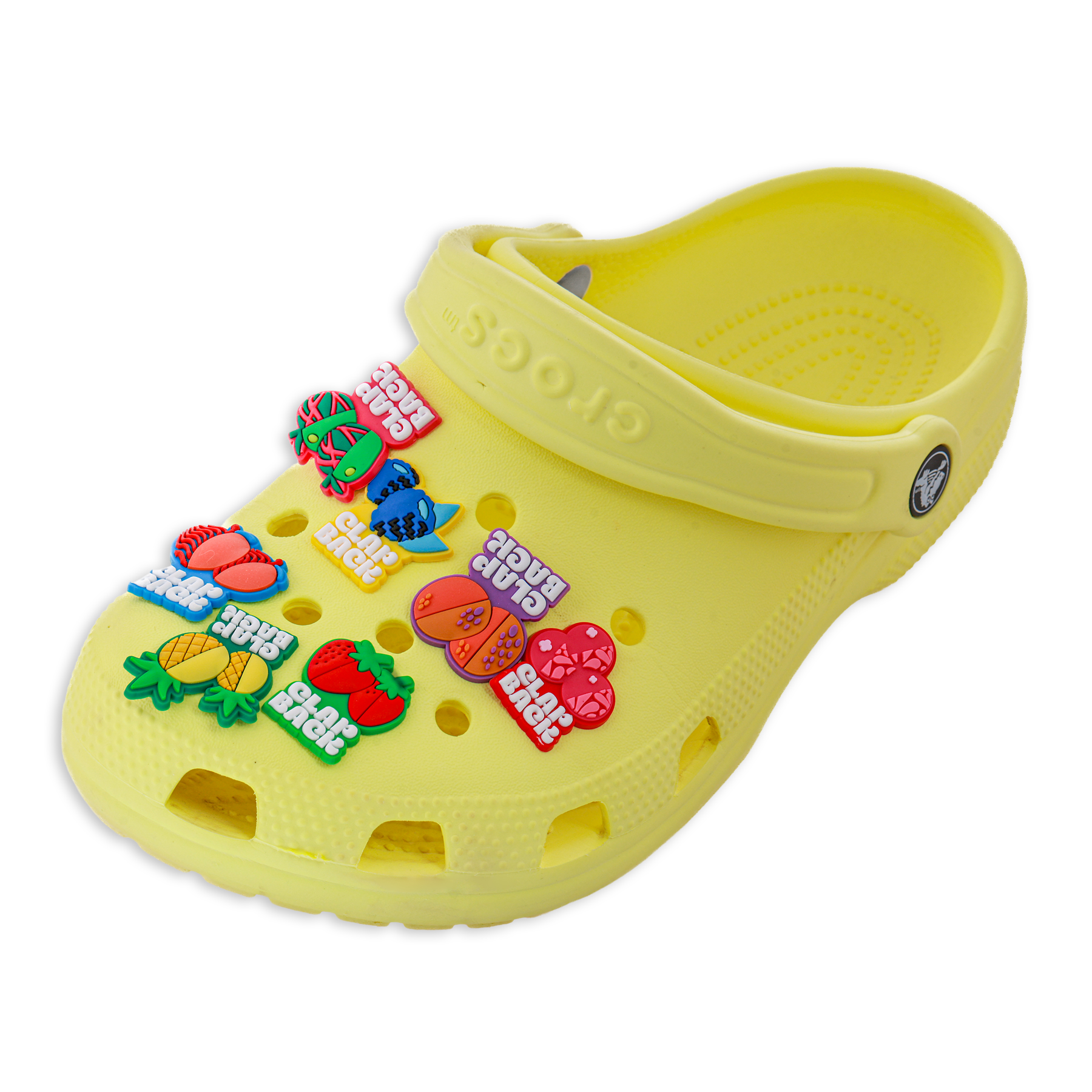 Yellow clog shoe with colorful fruit-themed decorations on a white background
