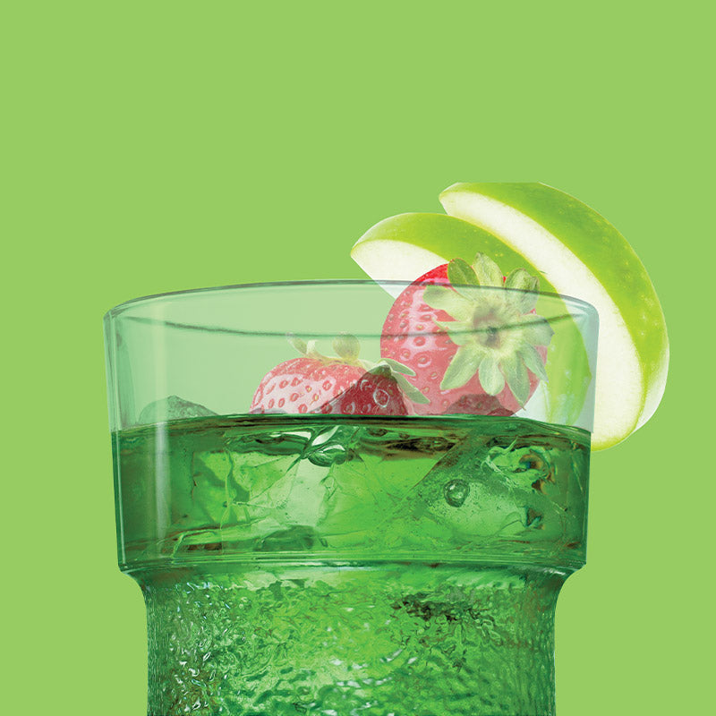 Clapback Me Apple Green glass with strawberries and a lime wedge on a green background