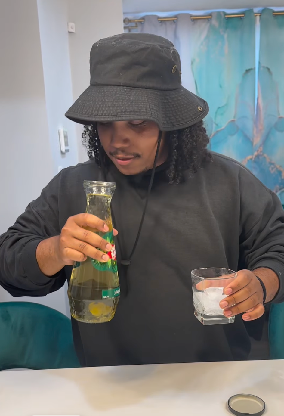 Man holding ClapBack Jalapeno Hoe with ice glass