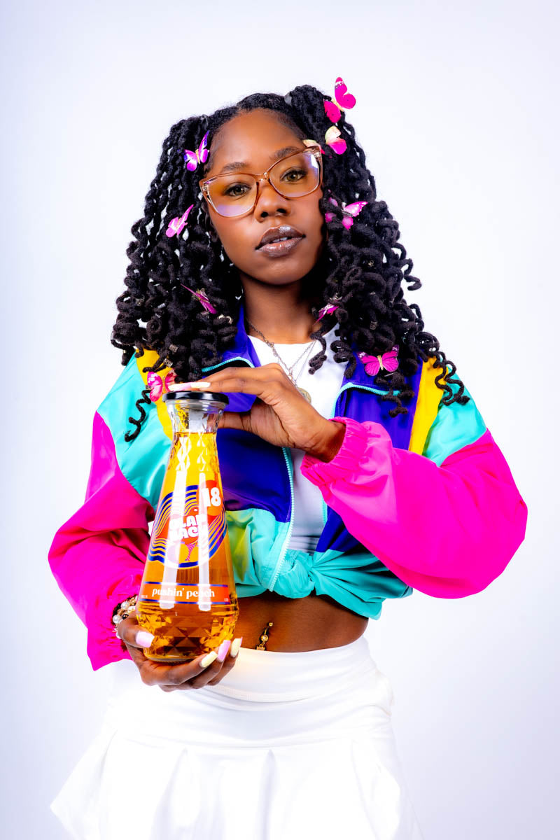 Woman holding a bottle of ClapBack wine - Photo by Jabril Williams