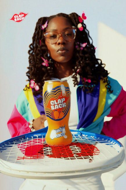 Woman holding a bottle of ClapBack wine - Photo by Jabril Williams