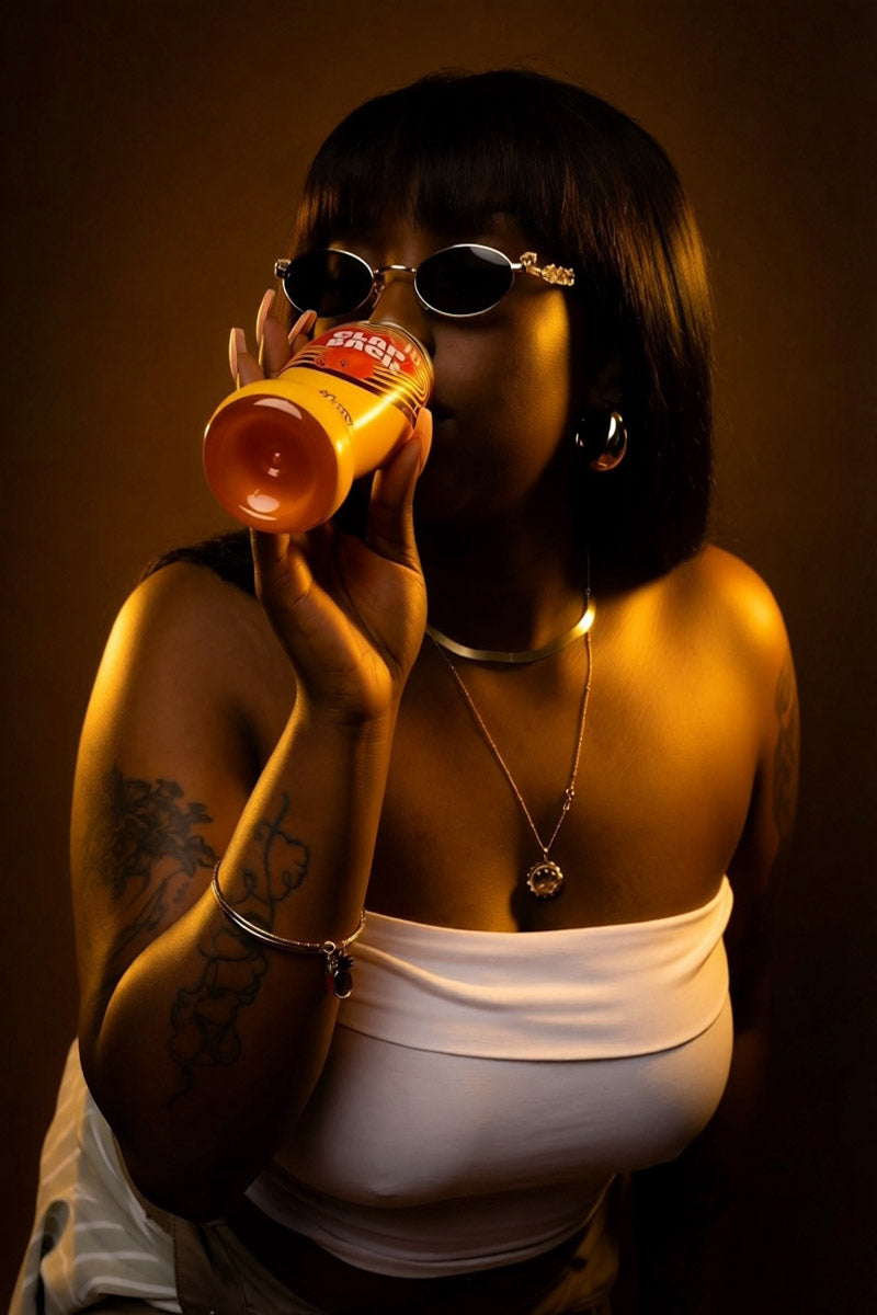 Woman holding a bottle of ClapBack wine - Photo by Jabril Williams