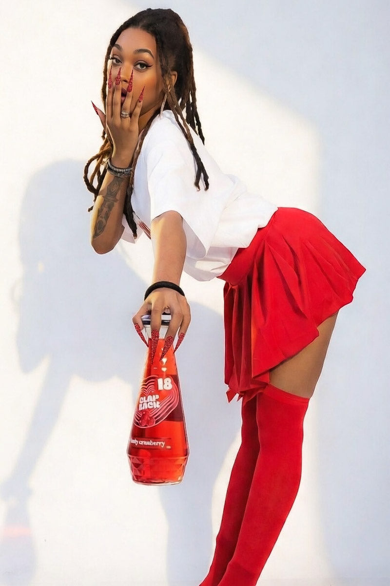 Woman holding a bottle of ClapBack wine - Photo by Jabril Williams