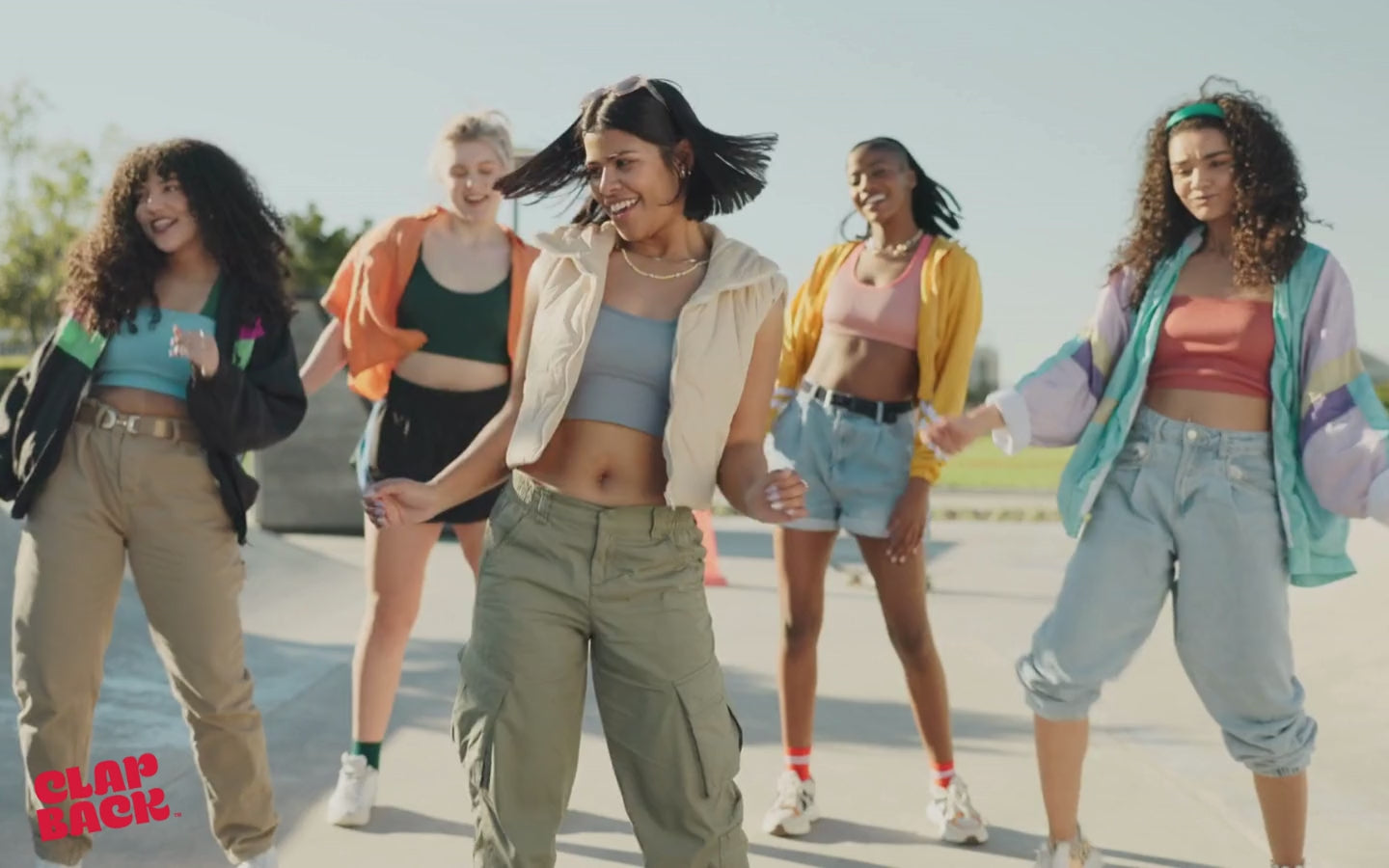 Friend group dancing and having fun with ClapBack logo approaching